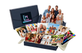 Collection of family photos displayed on a box with a photo album in the background.